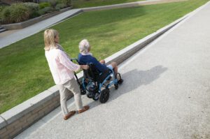 wheelchair hire in use outdoors, person pushing wheelchair