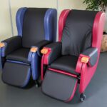 two tilt in space chairs different colours side by side