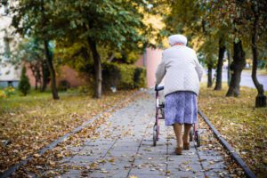 Elderly woman with the walker being used outdoors