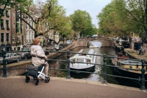 rollator being sat on by a person looking out over a canal