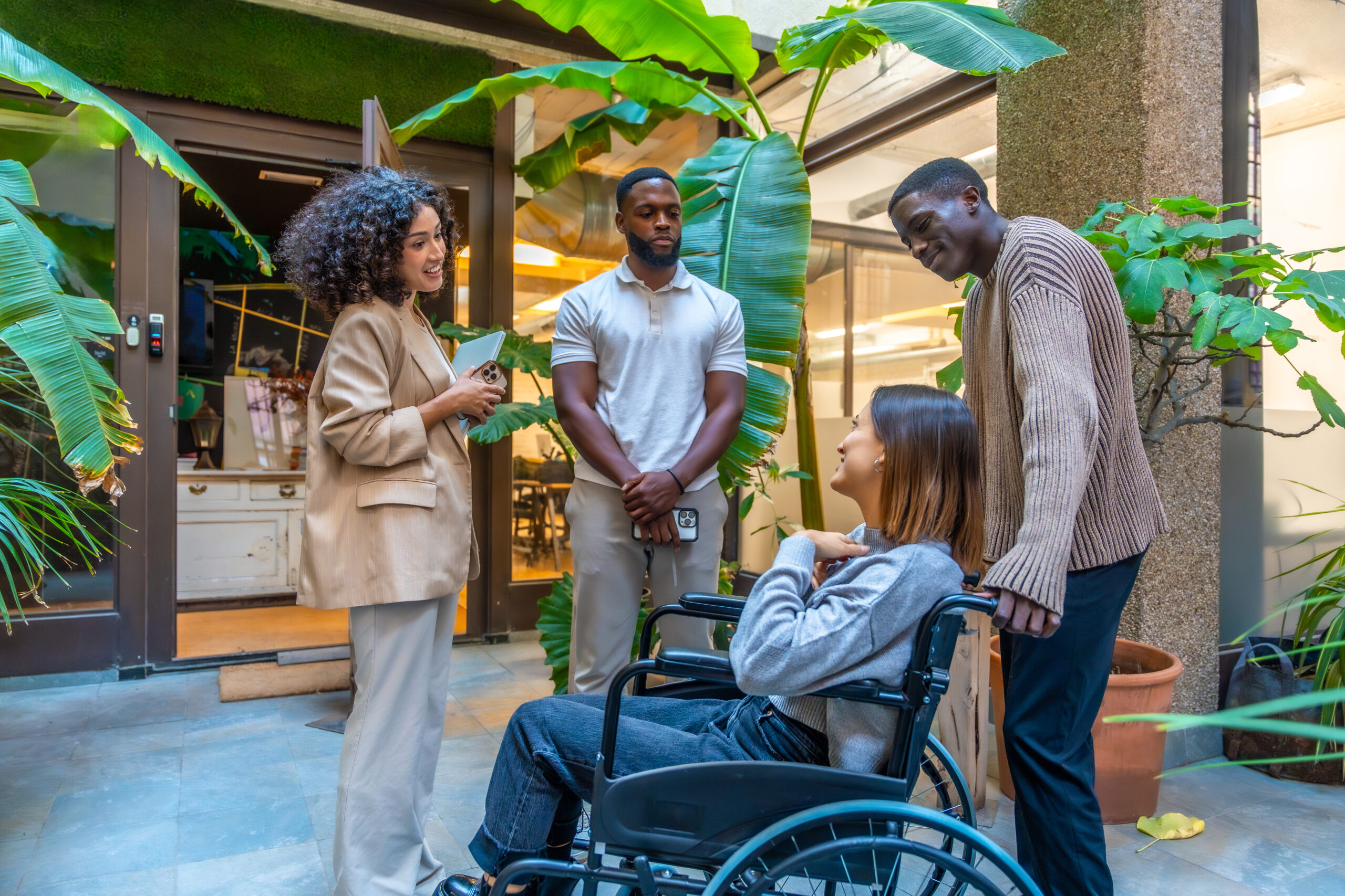 Disabled woman taking with multiethnic and diverse coworkers colleagues outside the modern coworking office