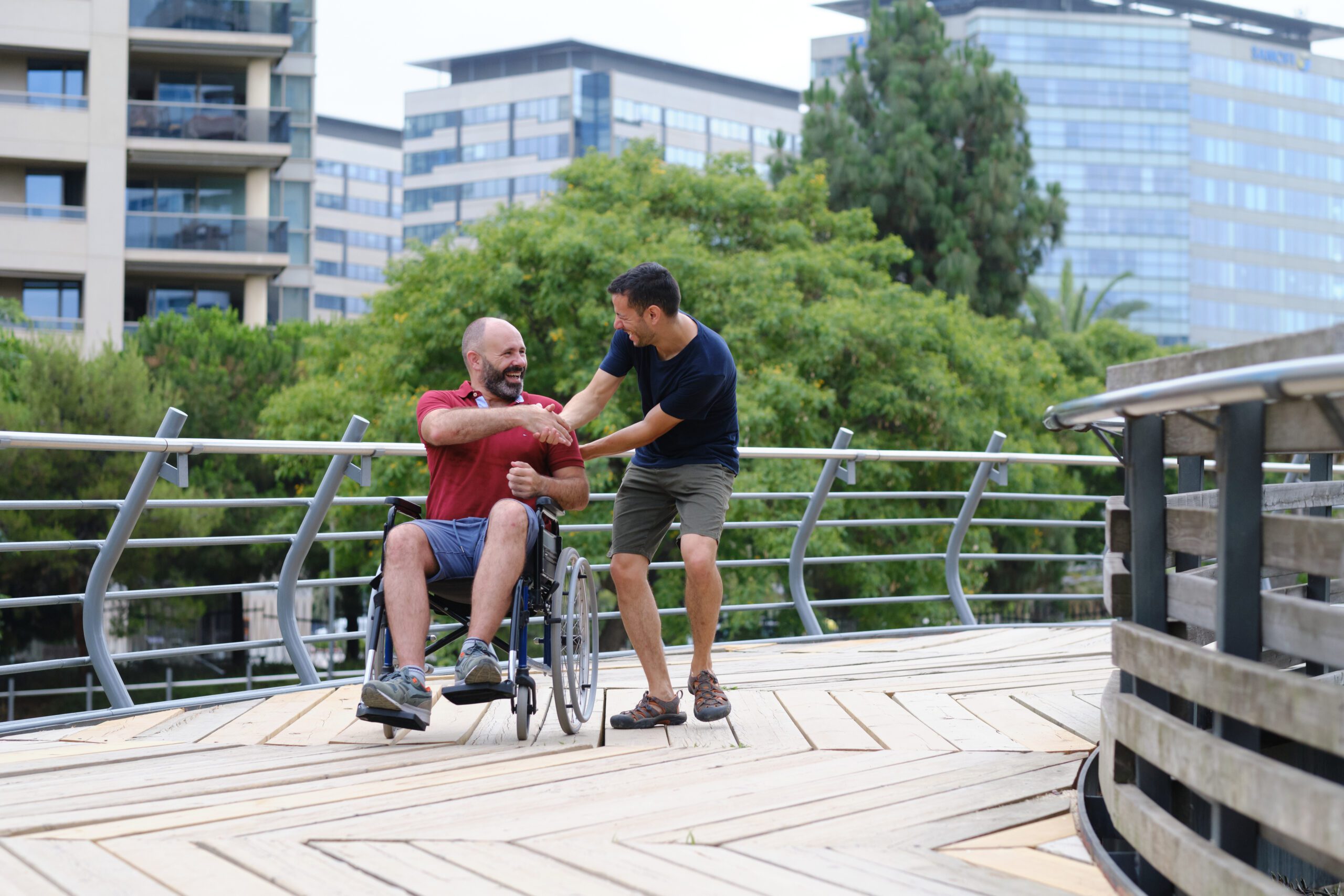 Carer Pushing Senior Man In Wheelchair - people with disabilites concept Carer Pushing Senior Man In Wheelchair - people with disabilites concept