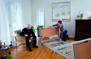 direct mobility professional setting up a hospital bed in a home
