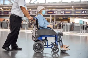 elderly woman with wheelchair in london airport